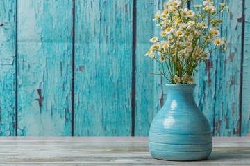 Blue pottery vase with black eyed susan flowers