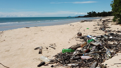 Plastic bottles, cups and other rubbish pollution on beach   