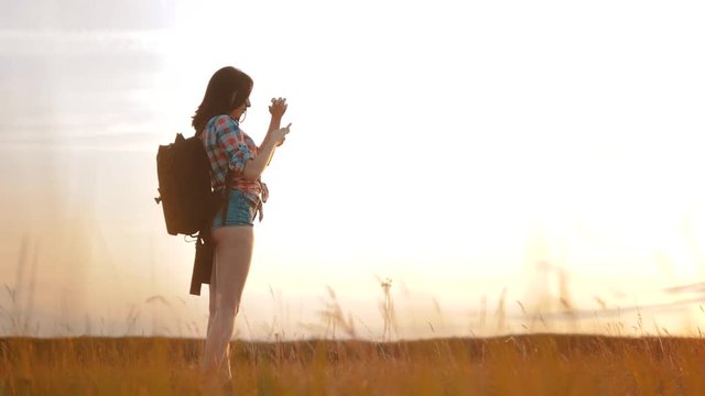 Hipster hiker silhouette girl is shooting video of beautiful nature sundown on cell telephone smartphone slow motion video. Female tourist is lifestyle taking photo with mobile phone camera. female
