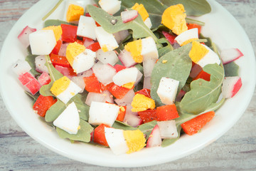 Fresh prepared salad in glass bowl, healthy nutrition concept