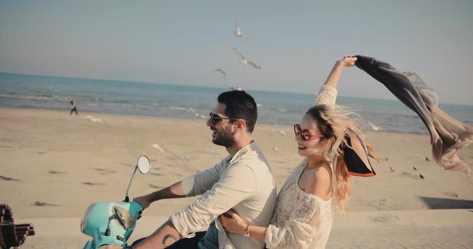 Young tourists couple riding scooter on Mediterranean island summer holidays