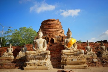Travel Thailand - Buddha statue in Wat Yai Chaimongkol on blue sky and cloud background, Ayutthaya...