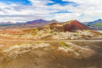 Aerial view of Iceland mountain desert landscape for vacation concept. Road trip travel car crossing through lava rocks volcanic mountains, nature background in Iceland. Travel adventure.
