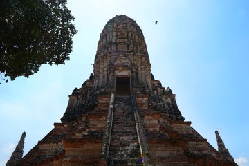Travel Thailand - Pagoda in Wat Chaiwatthanaram on blue sky and cloud background, Ayutthaya Historical Park. The brick pagoda at old ayutthaya temple ruins. Space for text in template.