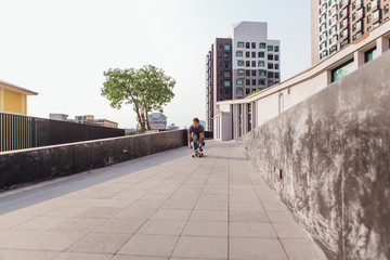 Young man riding skateboard on the street.