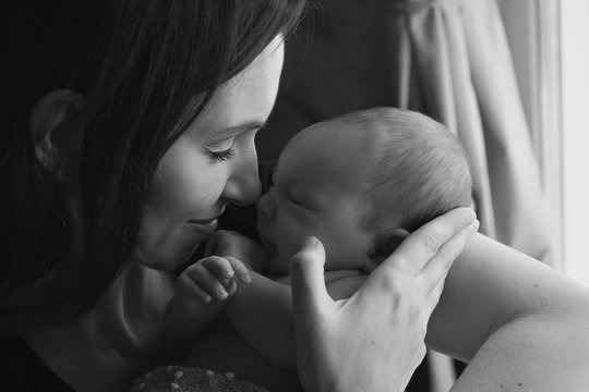 baby on the hands of mother on a white and black colours