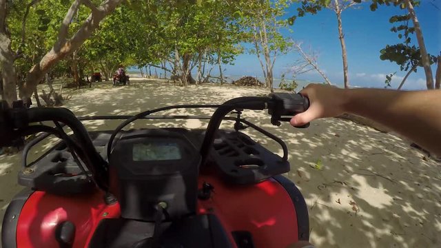 Quad biking tour in the Dominican Republic, Amber cove point of view gimbal shot on the beach.