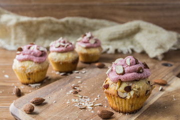 Muffins with strawberry foam on rustic wooden table 