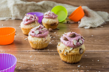 Muffins with strawberry foam on rustic wooden table 