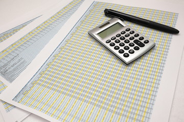 printout paper with calc and pen on desk