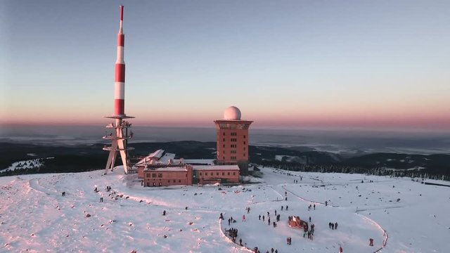 Aerial view of the Brocken peak in the Harz mountains in winter during sunset