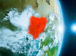 Naklejka premium Sunrise above Nigeria on planet Earth