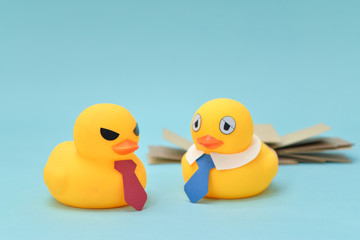 Office life concept, rubber duck and demanding boss
