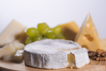 Different kinds of cheese on wooden background