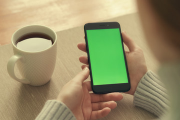 Woman hand holding mobile phone, She using in mobile applications and multimedia programs.