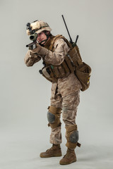 Soldier in camouflage holding rifle