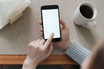 Close up of women's hands holding cell telephone with blank copy space screen for your advertising text message or promotional content.