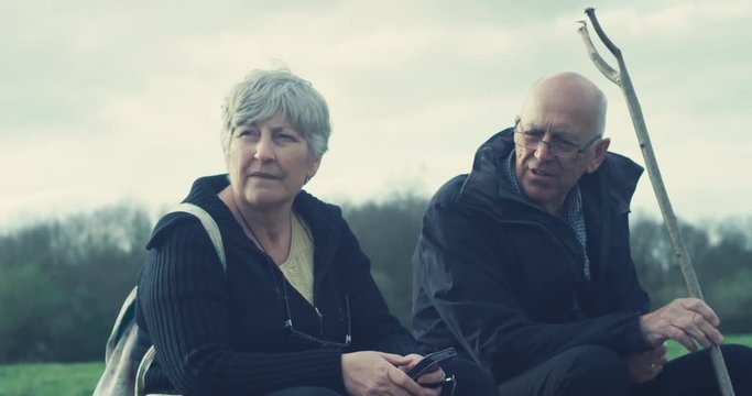 Senior couple sitting in forest