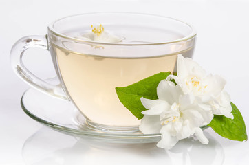 Glass cup of Tea with jasmine flowers and leaves