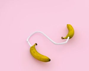 Creative idea layout fresh banana headphone against on pink color background. minimal idea food and...