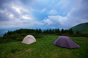 Tents in the mountains before storm