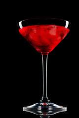 Cosmopolitan cocktail in nice red color in front of a black background