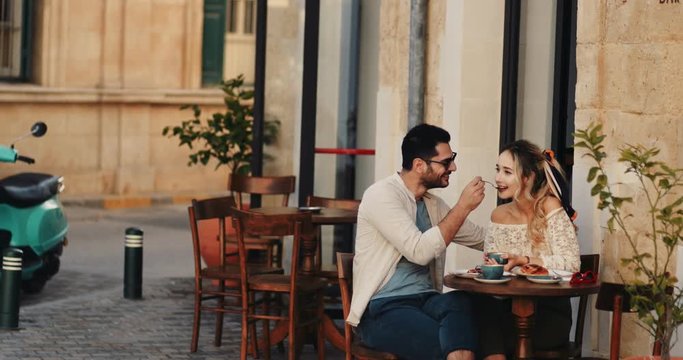 Tourists couple having a break at coffee shop in Europe