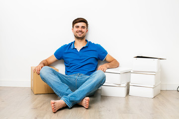 young man next to his cardboards ready to relocate