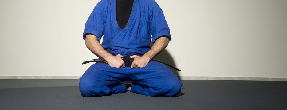 Close up of judo judo-gi whit belt isolated on white background - Powered by Adobe