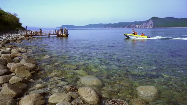 A motor boat sails along the blue sea and rolls holidaymakers, or delivers them to the island of Petrova