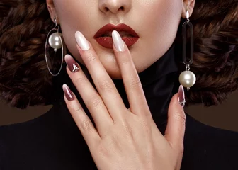 Poster Pretty girl with unusual hairstyle, bright makeup, red lips and manicure design. Beauty face. Art nails. Studio portrait © Kobrinphoto