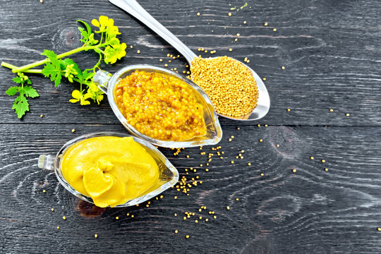 Sauce mustard in two sauceboats with flower on board top