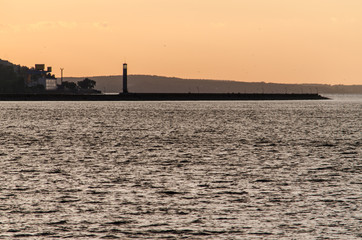 Landscape with silhouette of lighthouse in sunrice light
