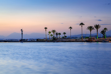 The harbour with lighthouse in Side at dusk, Turkey