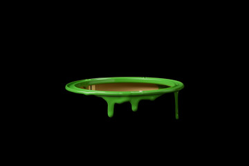 Colored oil paint leaking over the wall of empty metal bucket. Isolated