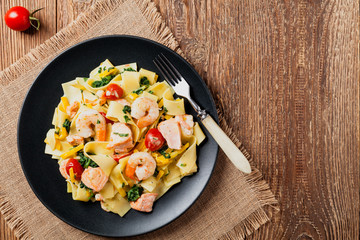 Traditional Italian fettuccini with salmon, shrimp and spinach.