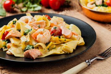 Traditional Italian fettuccini with salmon, shrimp and spinach.