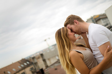 Romantic couple kissing on rooftop