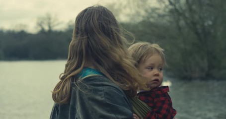 Mother and toddler by a lake