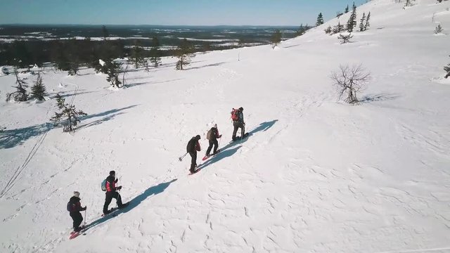 group of hiker walking on the snow mountain aerial view