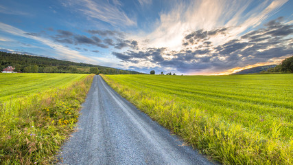 sunset over Norwegian countryside road