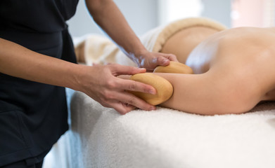 Fototapeta na wymiar Masseur massaging masseuse at wellness resort
