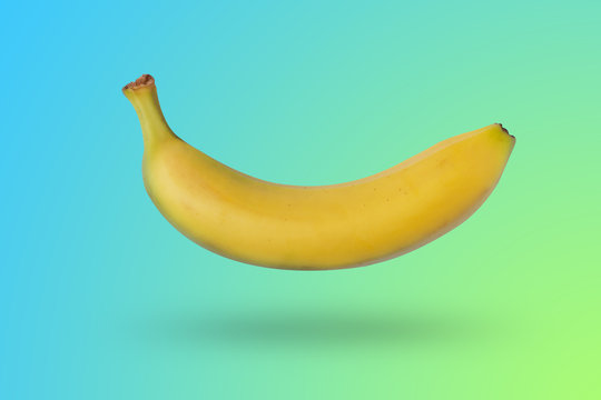 Banana isolated on gradient blue nd yellow background with a shadow