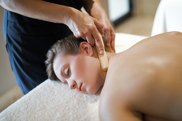 Masseur massaging masseuse at wellness resort