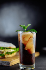 drink cocktail of cola with ice, mint and big sandwich Street food, fast food. Homemade burgers with beef