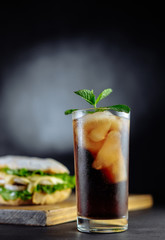 drink cocktail of cola with ice, mint and big sandwich Street food, fast food. Homemade burgers with beef