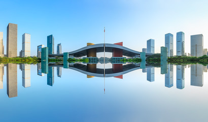 Beautiful modern city skyline and water reflection in Shenzhen at sunrise