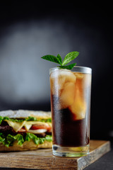 drink cocktail of cola with ice, mint and big sandwich Street food, fast food. Homemade burgers with beef