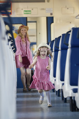 Cheerful little girl runs away from her mother at the train