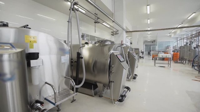 Factory white clean bright premises with placed special stainless steel tanks for pasteurization